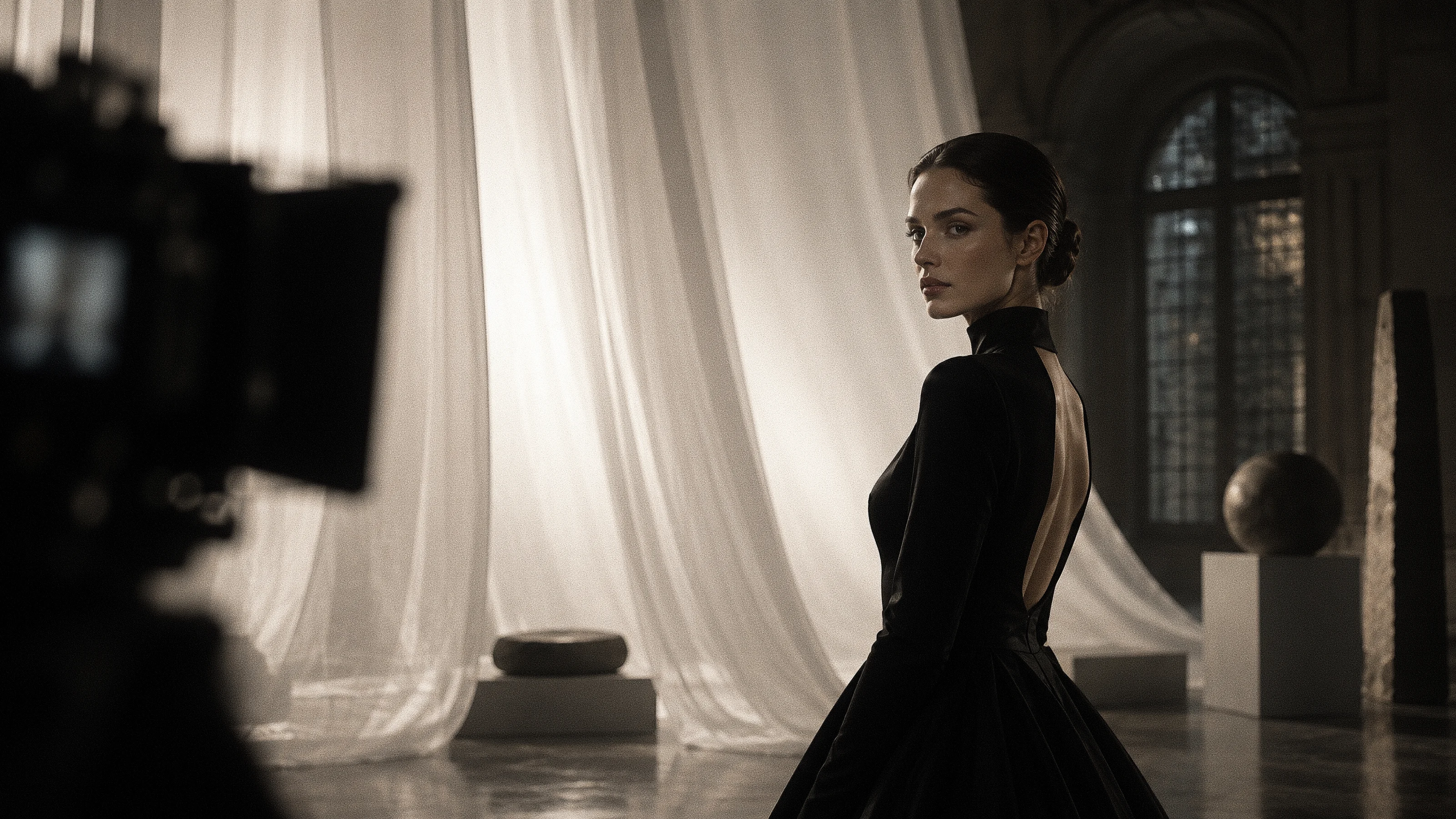 Model in a black gown on the Studio Sanch production set